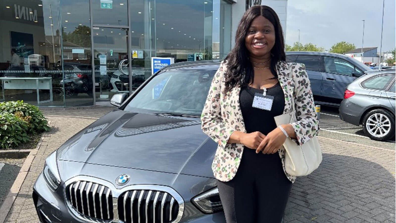 Picture of Moyosola at a car dealship