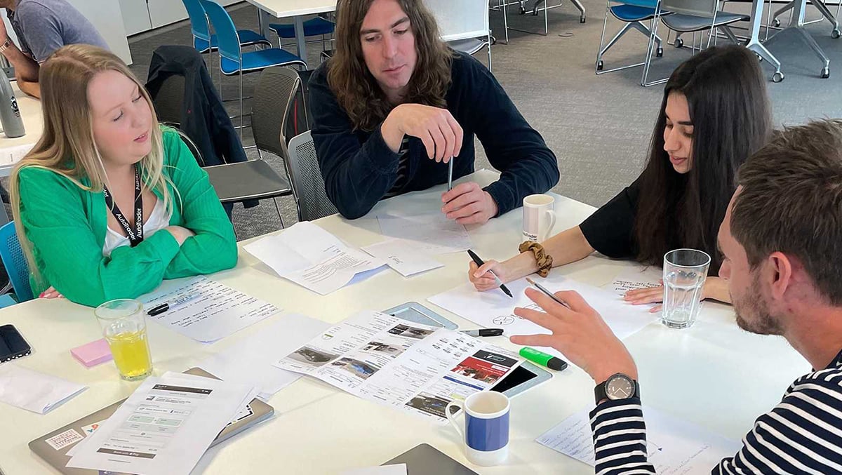 People sat around a table, discussing things